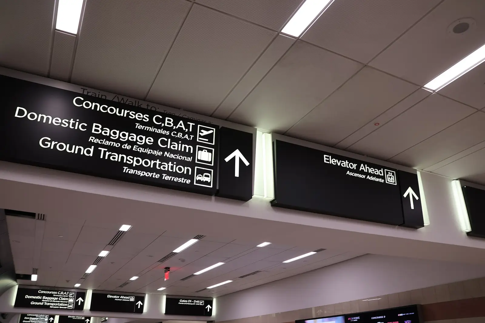 Signs pointing connecting passengers to concourses and gates at Hartsfield-Jackson Atlanta International Airport