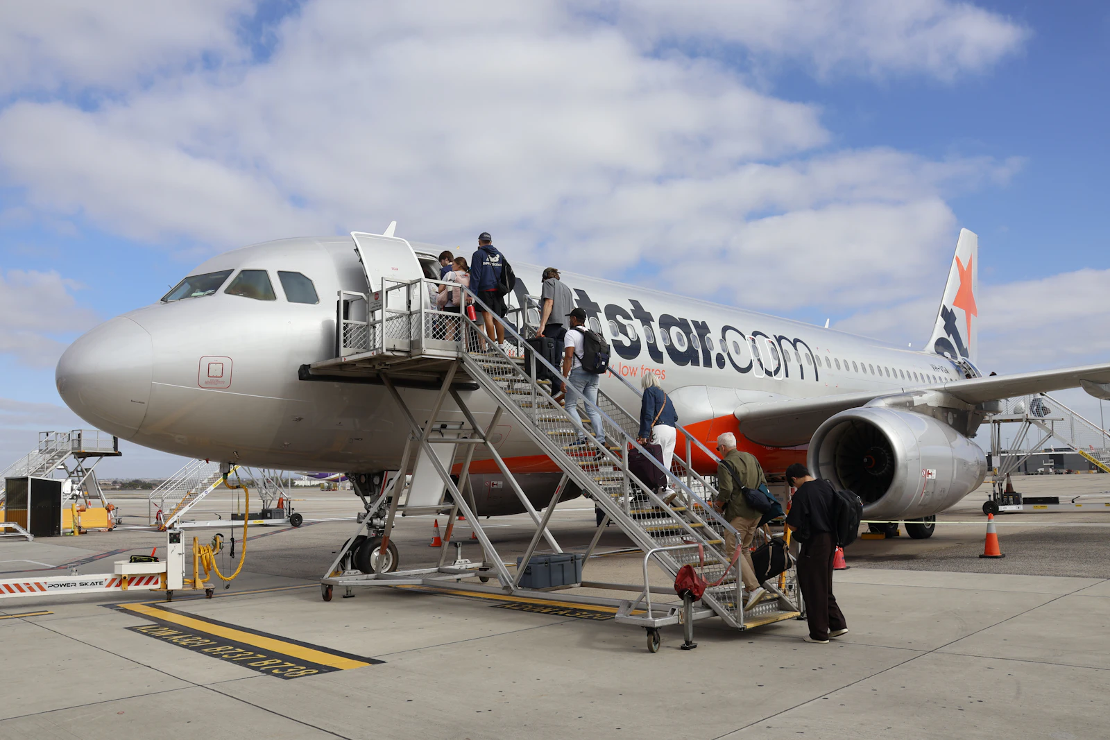 Passengers boarding an aircraft at an airport gate