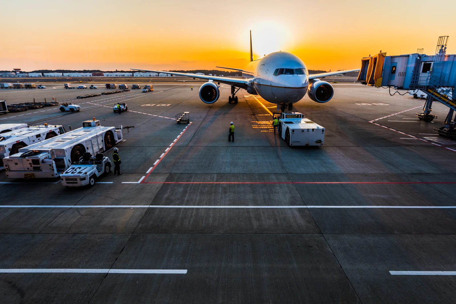 Aircraft parked at gates on an airport apron at dawn