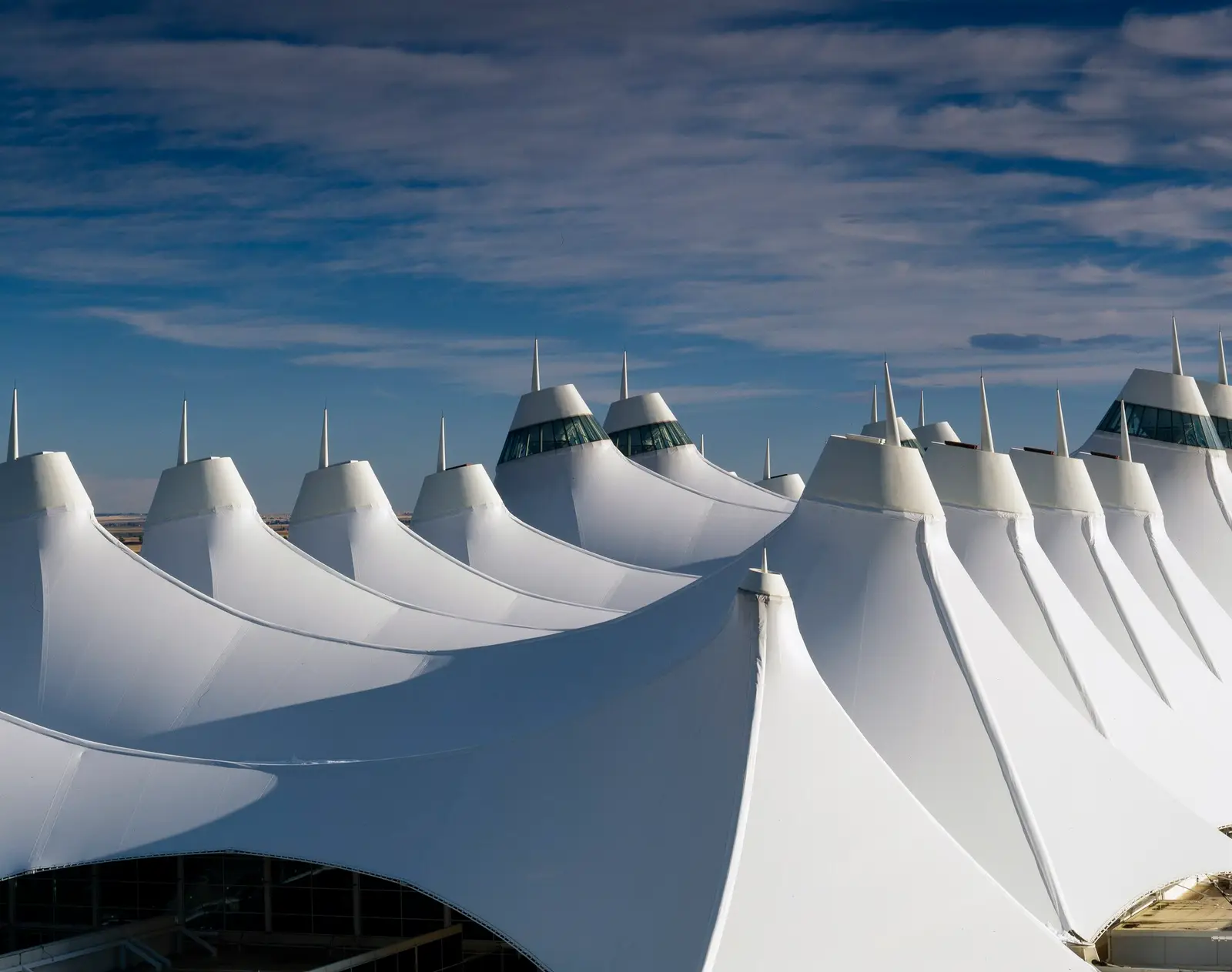 The peaked white fabric roof of the terminal at Denver International Airport