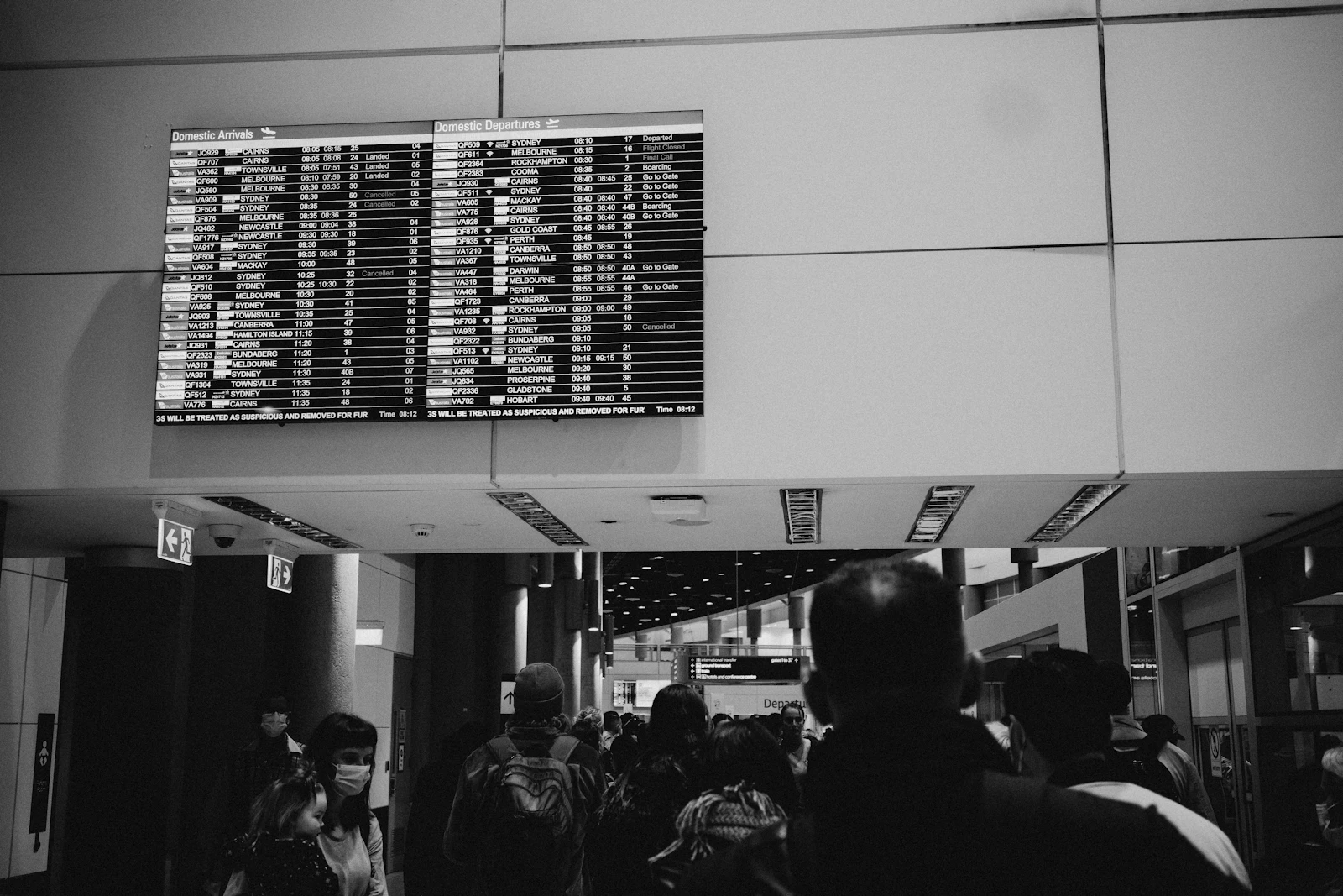 Departure board inside a US airport terminal showing scheduled flights