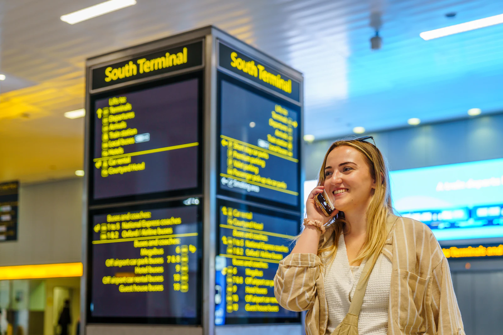 Traveller reading an airport information display board