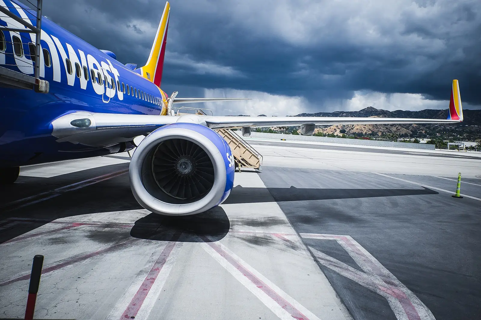A Southwest Airlines jet engine on the ramp under heavy evening cloud