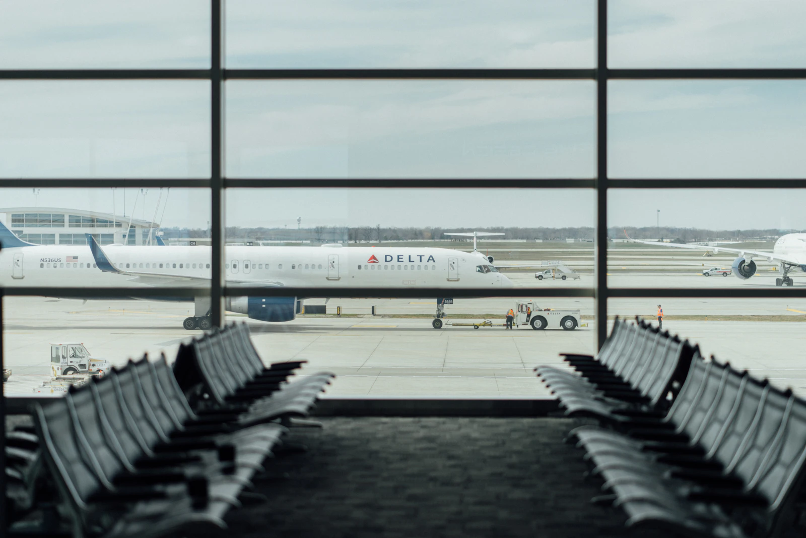 Aircraft seen through a terminal window at an airport gate